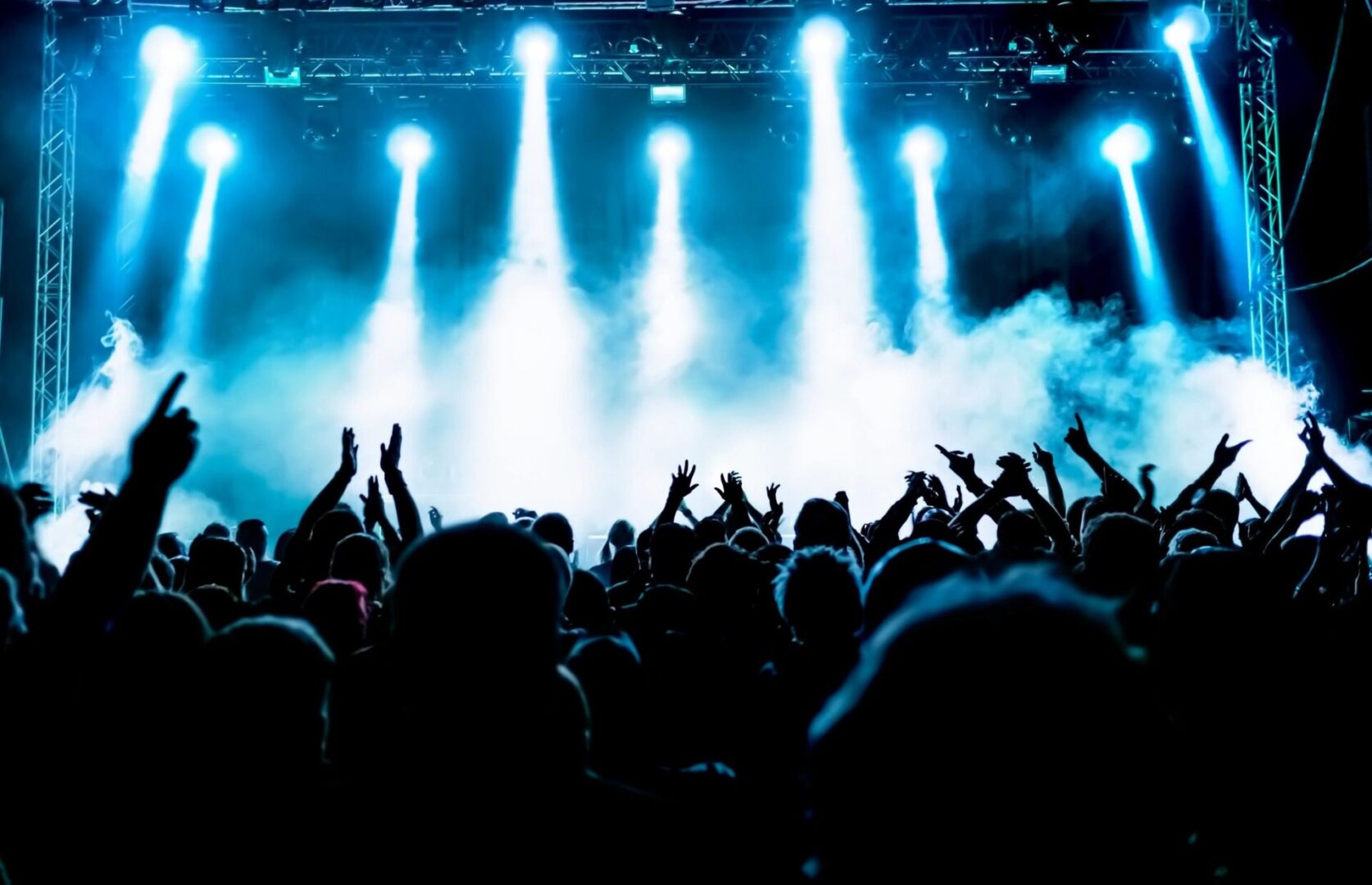 A crowd of people at an event with lights.