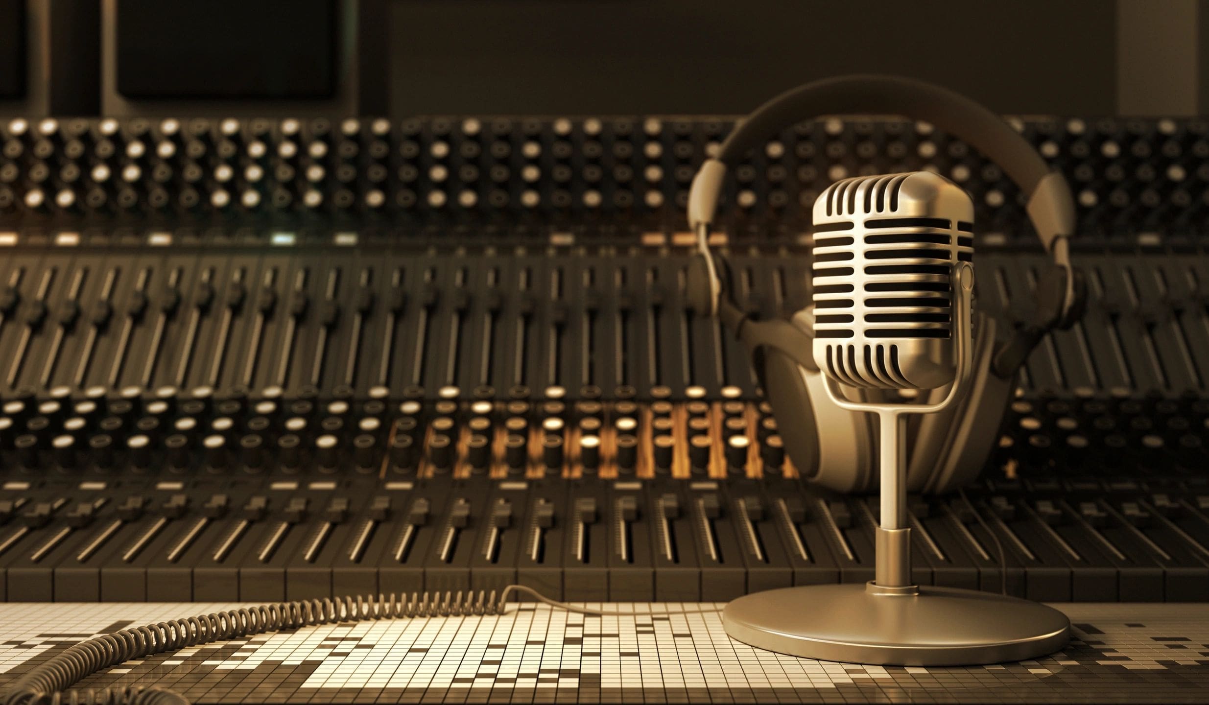 A microphone and headphones on top of a sound board.